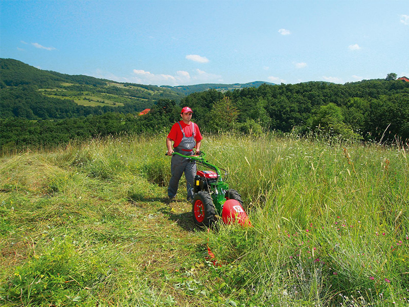 A farmer is using a power tiller, which is equipped with a Campes diesel engine. The direct injection technology makes the tiller more energy-efficient and more environmentally friendly.